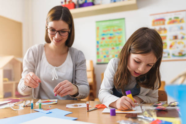 istock Preschool Teacher With Cute Girl - Creative Art Class 1008413268
