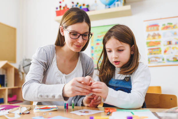 istock Preschool Teacher With Cute Girl - Creative Art Class 1008413270