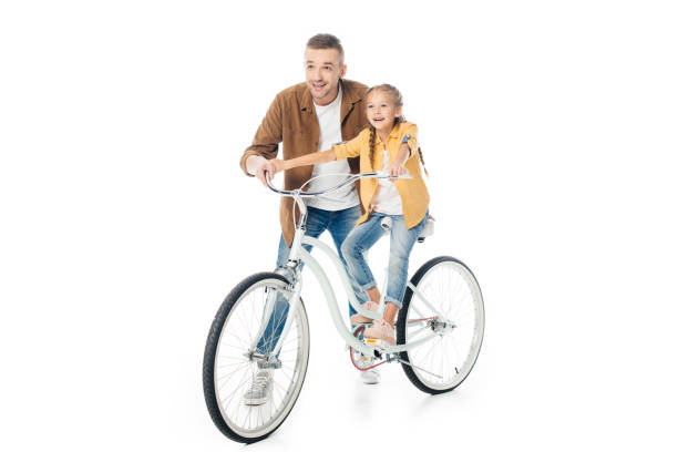 smiling father and little daughter on bicycle isolated on white