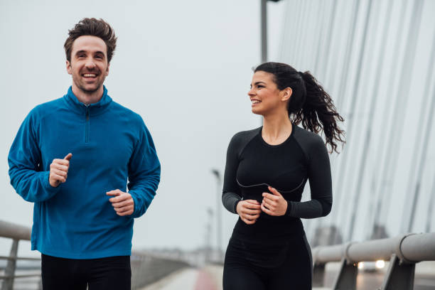 istock Female jogger looking at the man running next to her 1008418984