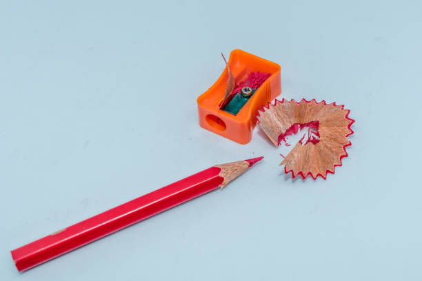 istock Selective Focus: Color pencil with sharpener shavings on white background 1008422074