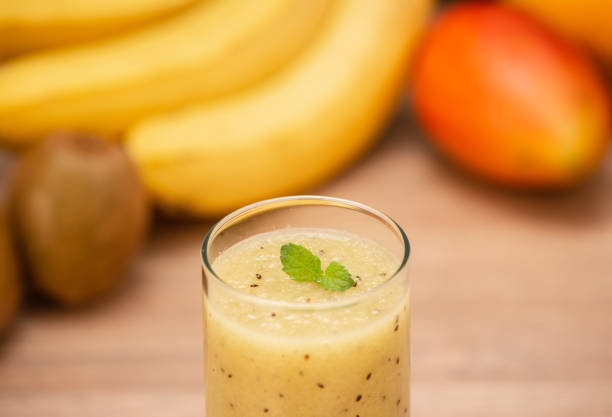 istock Tropical fresh fruit set and juice smoothies isolated with wooden background 1008422276