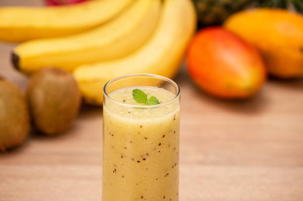 istock Tropical fresh fruit set and juice smoothies isolated with wooden background 1008422292