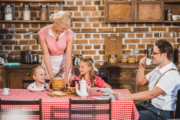 istock happy retro styled family having breakfast together 1008440156