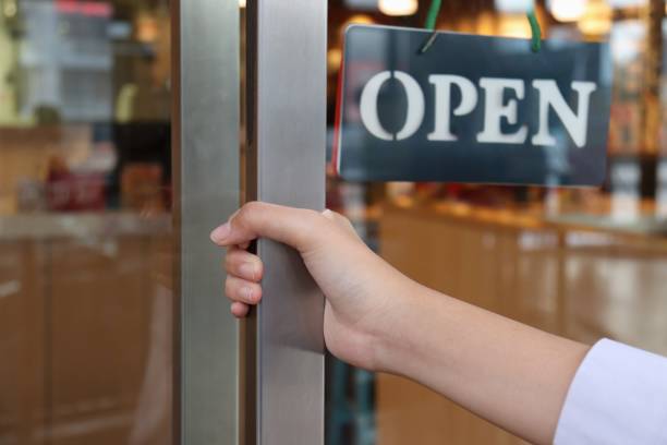 hand on handle door  for open  to entering  restaurant