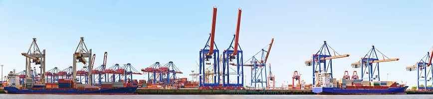 panoramic view of a container harbour with container ships and bridges at Hamburg, Germany