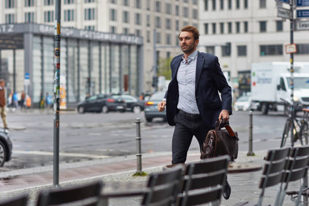 istock Businessman carrying bag while walking by street 1008457826