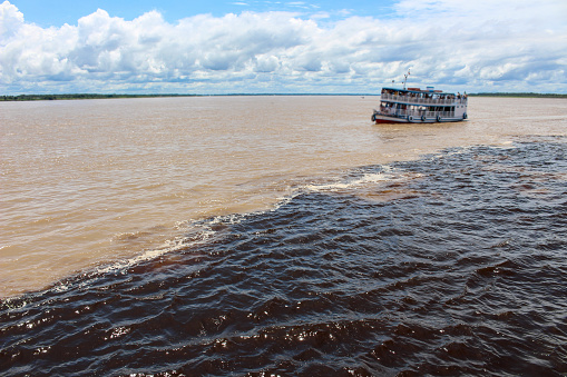 Meeting of the Waters of Rio Negro and the Amazon River or Rio Solimoes near Manaus, Amazonas, Brazil in South America