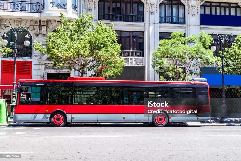 Red city bus with copy space Side view of a red bus in a city street. Useful copy space available for text and/or logo in the bus side. DSRL outdoors photo taken with Canon EOS 5D Mk II and Canon EF 24-105mm f/4L IS USM Wide Angle Zoom Lens Bus Stock Photo