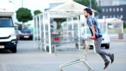 Man Have Fun On The Parking Shopping Mall Happy Funny Guy Rides On Shopping  Cart Customer With Shopping Trolley Near Supermarket Stock Video - Download  Video Clip Now - iStock