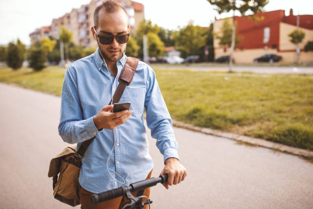 istock Young man riding push scooter in the city 1008488824