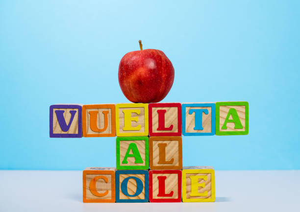 istock Back to School spelled out in spanish with wooden blocks with apple 1008492154