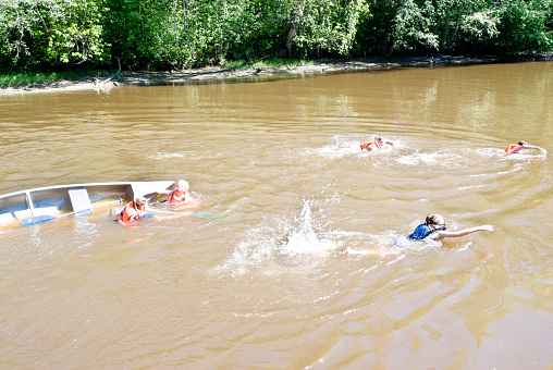 Bukit Lawang, Sumatra, Indonesia - January 21th 2024:  People having fun bathing in a river on a hot tropical day