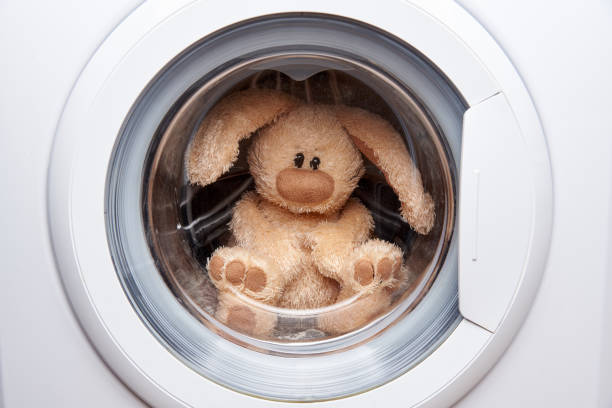 istock Soft toy hare in the washing machine 1008498536