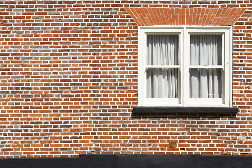 Traditional sash window and red brick wall background with copyspace