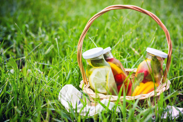 istock Selection of summer lemonades. Basket on the meadow with refreshing drinks 1008509792