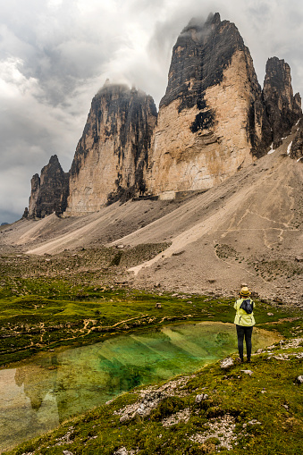 Hiker looking at the Tre Cime di Lavaredo National Park, Dolomites, European Alps, Italy,Nikon D850