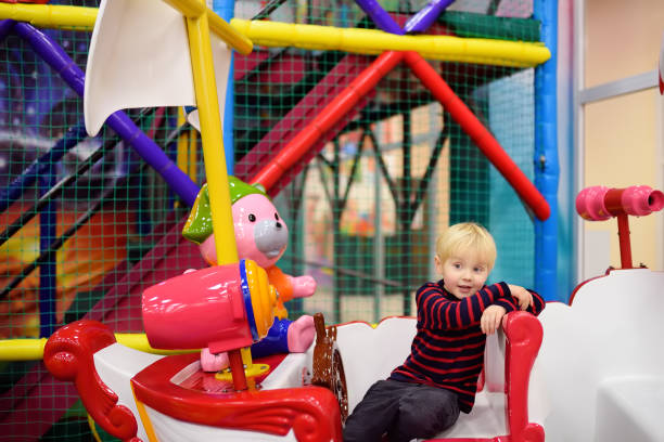 istock Happy little boy having fun in amusement in play center 1008515710