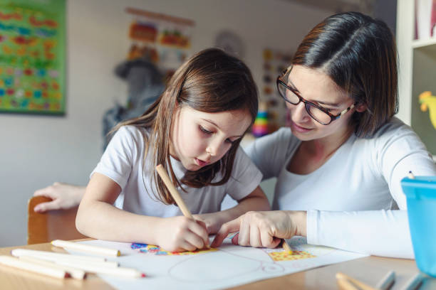 istock Mother with her child having creative and fun time drawing 1008524920