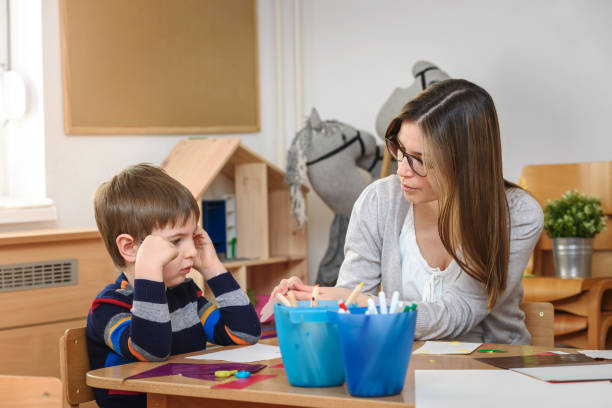 istock Teacher supports baby boy at kindergarten 1008525160