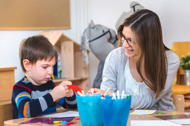 istock Teacher supports baby boy at kindergarten 1008525202