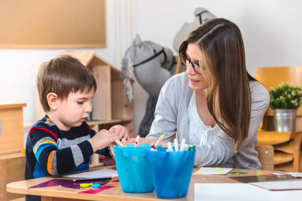 istock Teacher supports baby boy at kindergarten 1008525232
