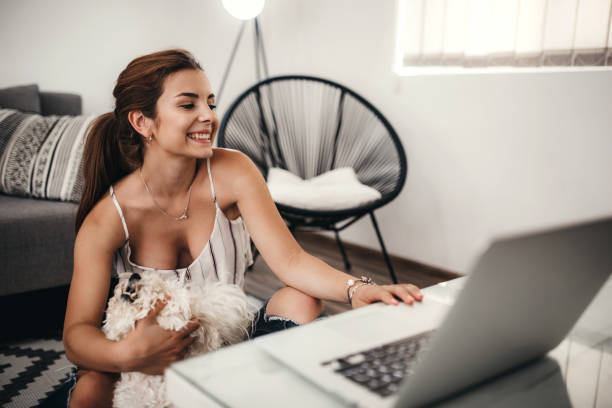 Woman sitting on the floor and using laptop