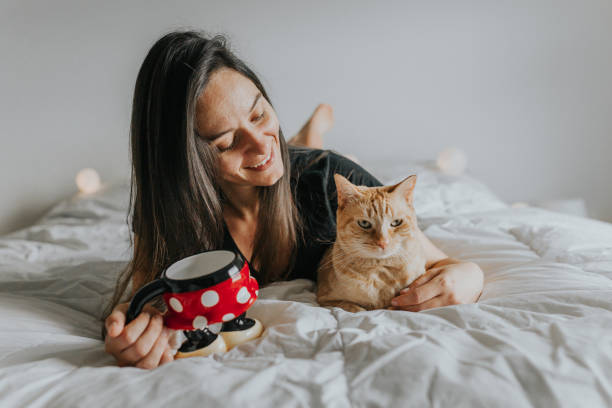 istock Woman in Bed with Cat 1008540930