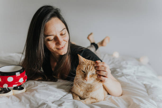 istock Woman in Bed with Cat 1008540954