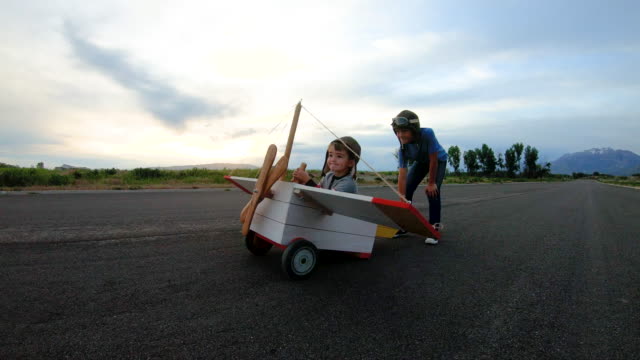 Two Young Boys Flying Vintage Toy Plane