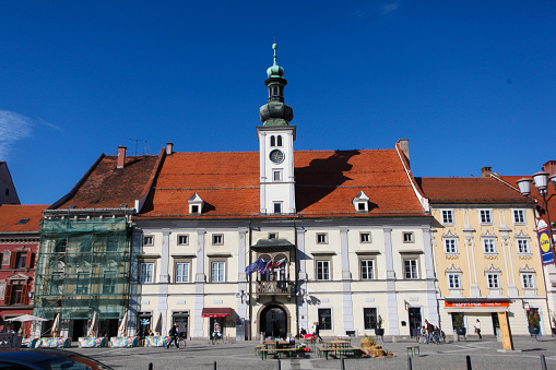Town square with Plague monument and city hall in Maribor, Slovenia.