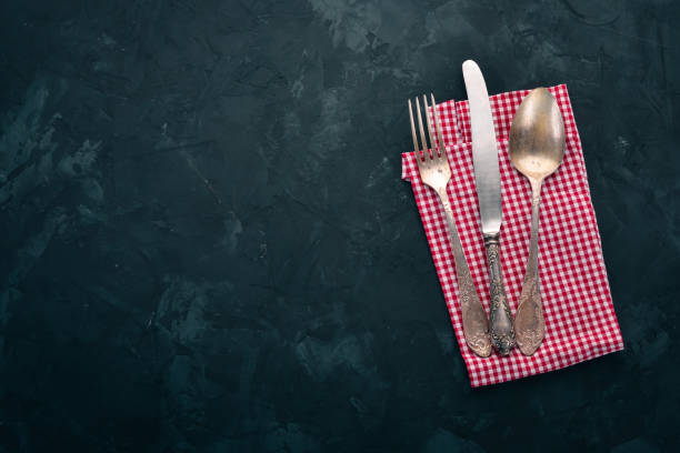 istock Old cutlery. On a black stone background. Top view. Free space for text. 1008569486