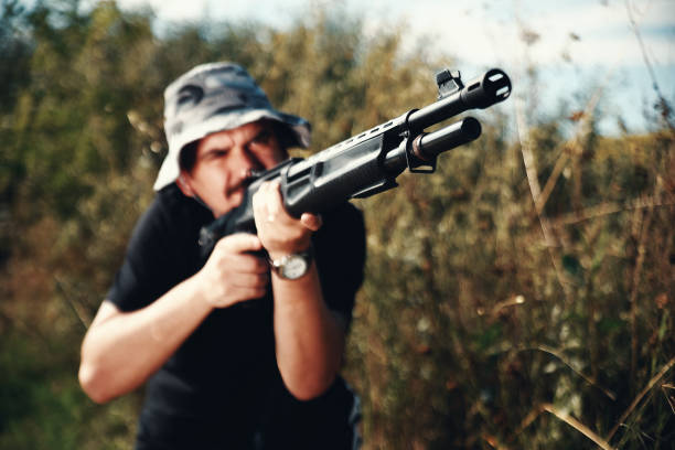 istock Male hunter aiming his rifle and preparing to shoot 1008570114