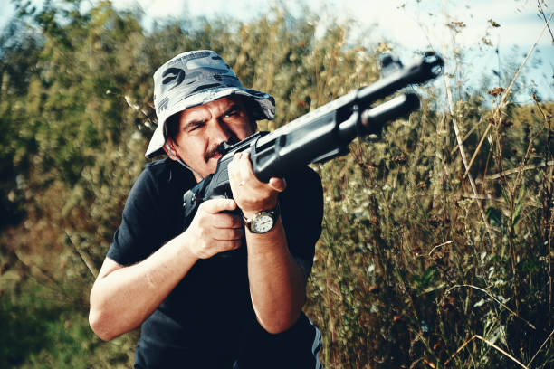 istock Male hunter aiming his rifle and preparing to shoot 1008570326