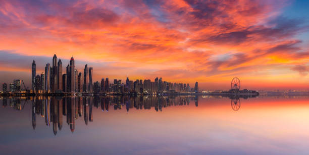 istock Panorama of Dubai Marina skyline at sunset with a beautiful dramatic sky 1008573372
