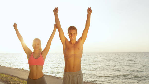 istock COPY SPACE: Happy Caucasian couple celebrates successfully completing summer jog 1008573374