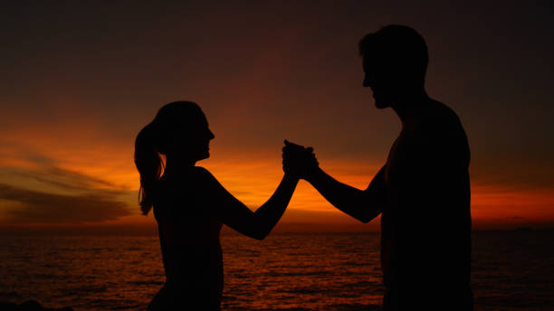 istock CLOSE UP: Joyful couple smiling in the sunset shakes hands after awesome workout 1008573426