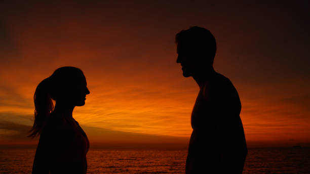 istock CLOSE UP: Smiling couple looks deep into each other's eyes on summer evening. 1008573442
