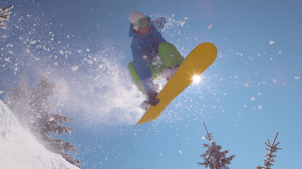 istock CLOSE UP: Professional snowboarder does a mid-air grab during his downhill ride 1008573470