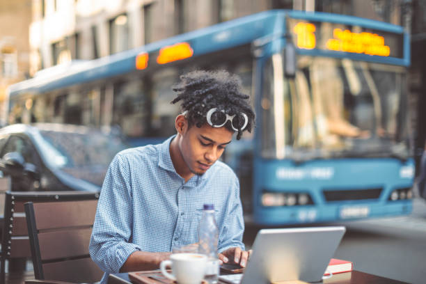 Young businessman in a coffee shopp Young businessman in a coffee shopp bus hungary stock pictures, royalty-free photos & images