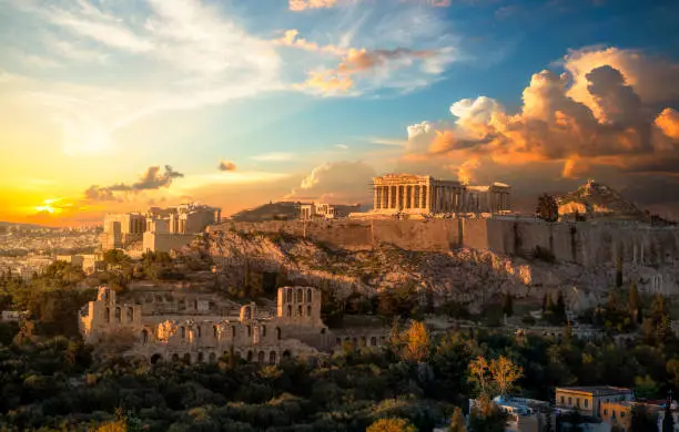Photo of Acropolis of Athens at sunset with a beautiful dramatic sky
