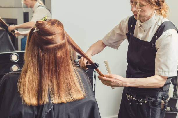 istock Hairdresser making a hairstyle for client 1008592396