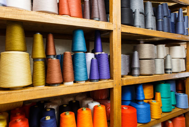 istock Any color industrial sewing spools of thread on the shelf 1008592910