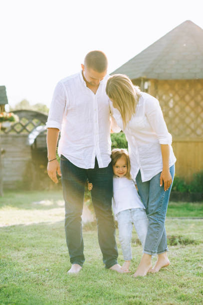istock parents and cute little child standing on backyard 1008600486