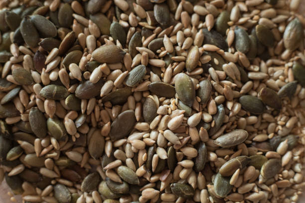 Pumpkin, sunflower and sesame seed dry-fried in frying pan, close-up,