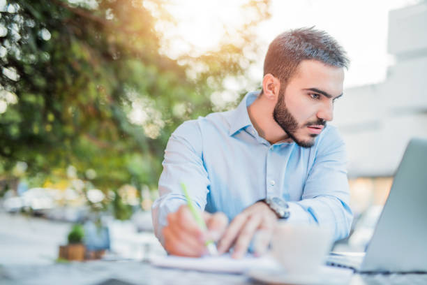 istock Man working outdoors in coffee shop. 1008620786
