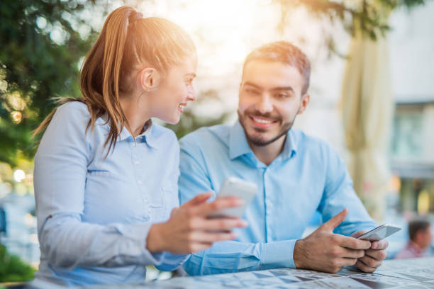 istock Happy young couple using social media on a smart phone together. 1008628100