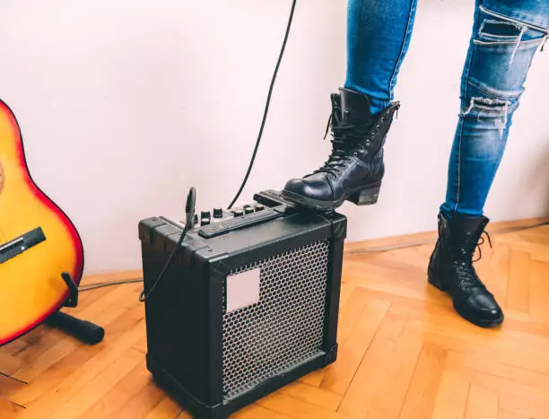 Photo of Boot stepping on guitar amp