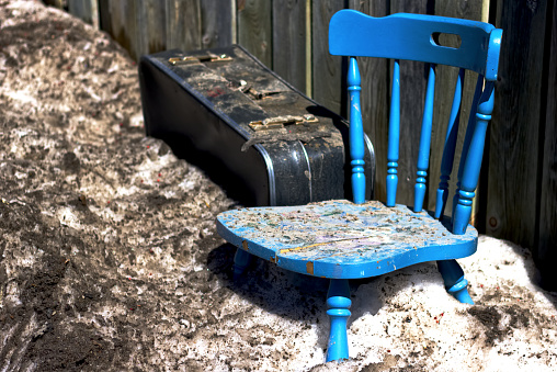 The spring melt revels a forgotten chair.