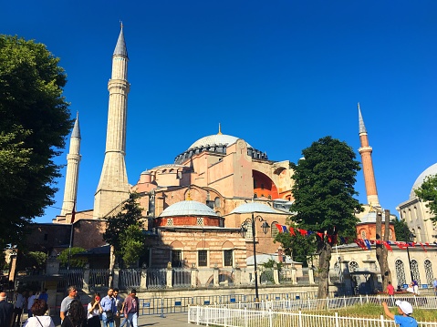 Istanbul, Turkey - June 12, 2018: Hagia Sophia Museum from the Sultanahmet Square and tourists around it.